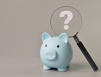 Piggy bank with question mark spyglass